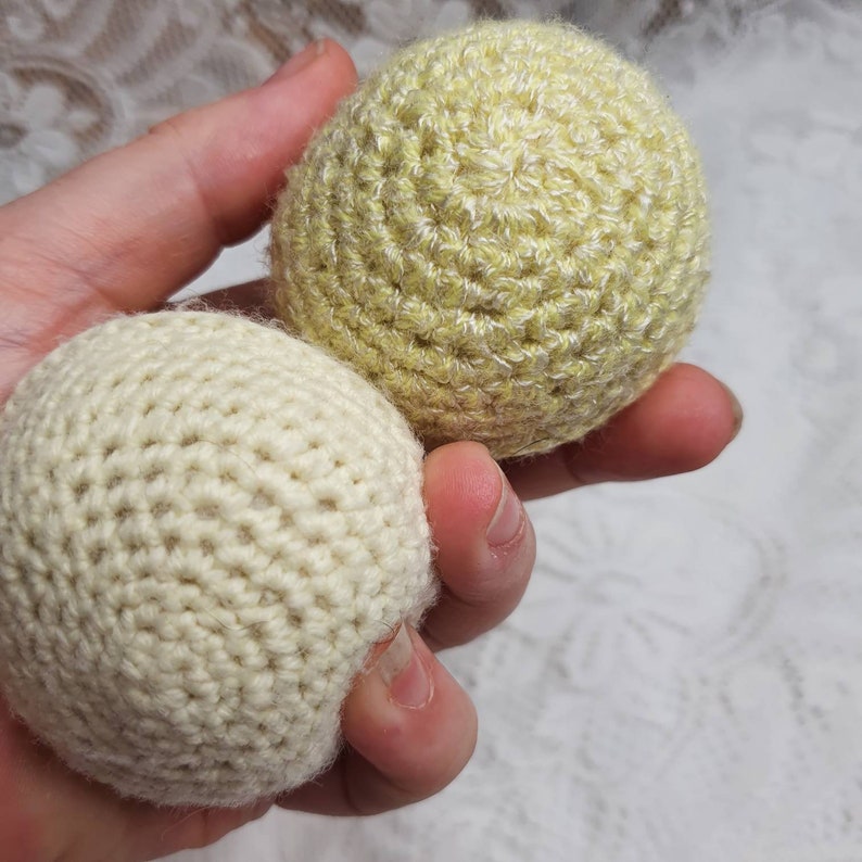 Handknitted wool ball rattles.