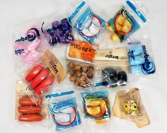 May include: Assortment of beads in various shapes and colors, packaged in clear plastic bags. Includes pink, purple, red, brown, white, yellow, and blue beads. Some bags are labeled "Marbella Quality Beads" and "Wang's".