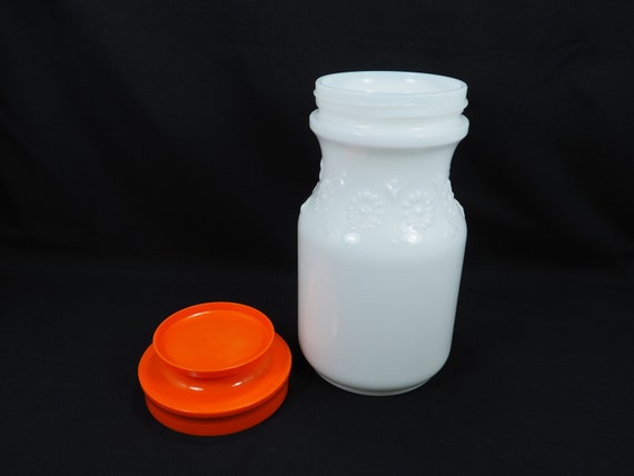 Milk Glass Tang Jar With Orange Lid and Embossed With Flowers 