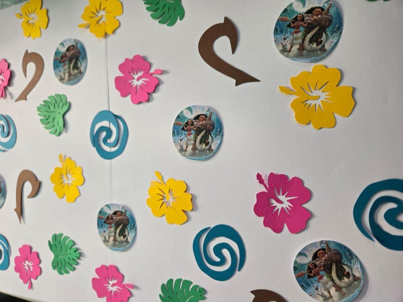 Pode incluir: Um fundo branco com v&aacute;rios recortes de papel, incluindo um redemoinho azul, ganchos marrons, folhas verdes e flores de hibisco rosa, amarelas e vermelhas. H&aacute; tamb&eacute;m duas imagens redondas de Moana e Maui do filme da Disney Moana.