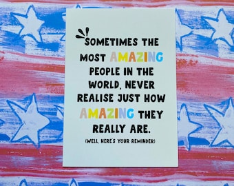 May include: A white card with a colorful message that reads "Sometimes the most amazing people in the world, never realize just how amazing they really are. (Well, here's your reminder)"