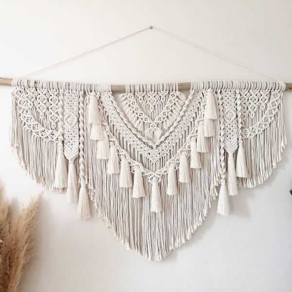 Large macramé wall hanging with “TICYA” pompoms