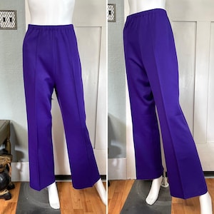 May include: A pair of wide-leg trousers in a vibrant purple colour. The trousers have a high waist and a straight leg.