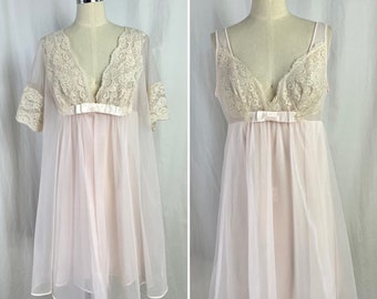 May include: A pink sheer nightgown with lace trim and a satin bow at the waist. The nightgown has short sleeves and a V-neckline.