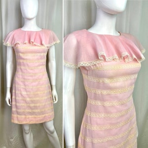May include: A pink and white striped dress with a lace trim and a ruffled collar. The dress has short sleeves and a fitted bodice.