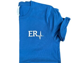 May include: A royal blue t-shirt with a white graphic of the letters "ER" and a heartbeat. The text "ER ESSENTIALS" is printed below the image.