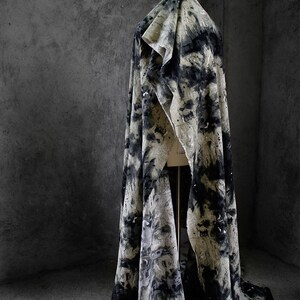 May include: A black and white patterned fabric draped over a mannequin. The fabric has a textured, abstract design.