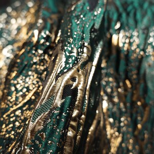 May include: Close-up of a green and gold fabric with a textured pattern. The fabric has a metallic sheen and is likely used for clothing or upholstery.