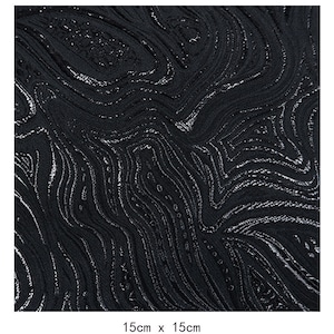 May include: Black fabric with a silver metallic swirl pattern. The fabric is 15cm by 15cm.