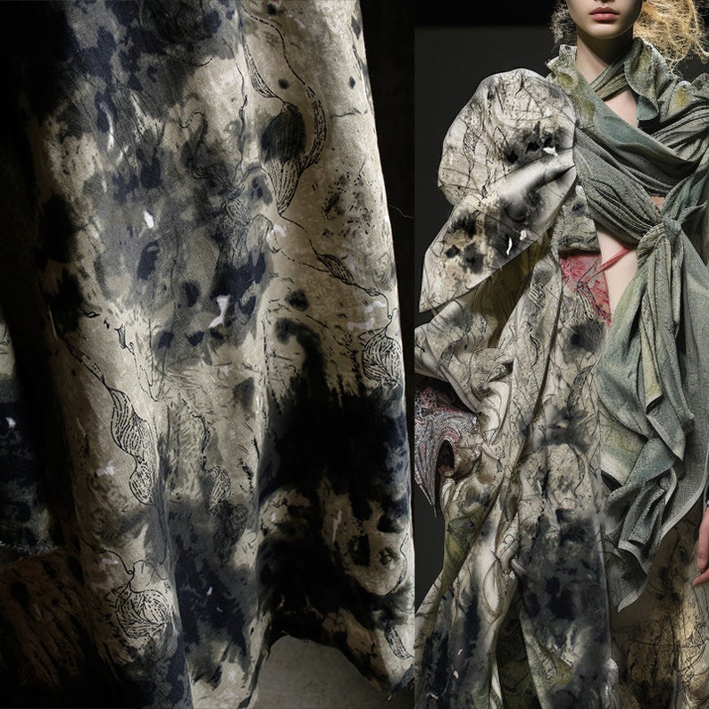 May include: A close-up of a fabric with a black and white abstract pattern. The fabric is draped over a surface and has a textured look.