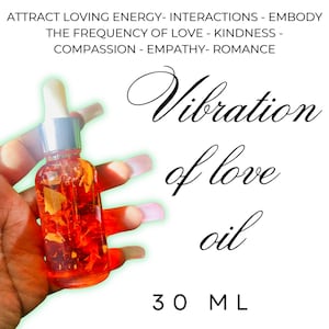 May include: A clear glass dropper bottle containing bright red oil with visible botanical inclusions. The text reads: ATTRACT LOVING ENERGY- INTERACTIONS - EMBODY THE FREQUENCY OF LOVE - KINDNESS - COMPASSION - EMPATHY- ROMANCE, Vibration of love oil, 30 ML.