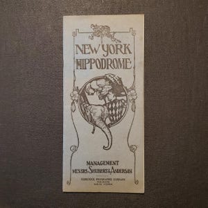 May include: Vintage New York Hippodrome program. The cover features the text "NEW YORK HIPPODROME" in an ornate font, with an illustration of an elephant and performers. The program is from the Comstock Programme Company.