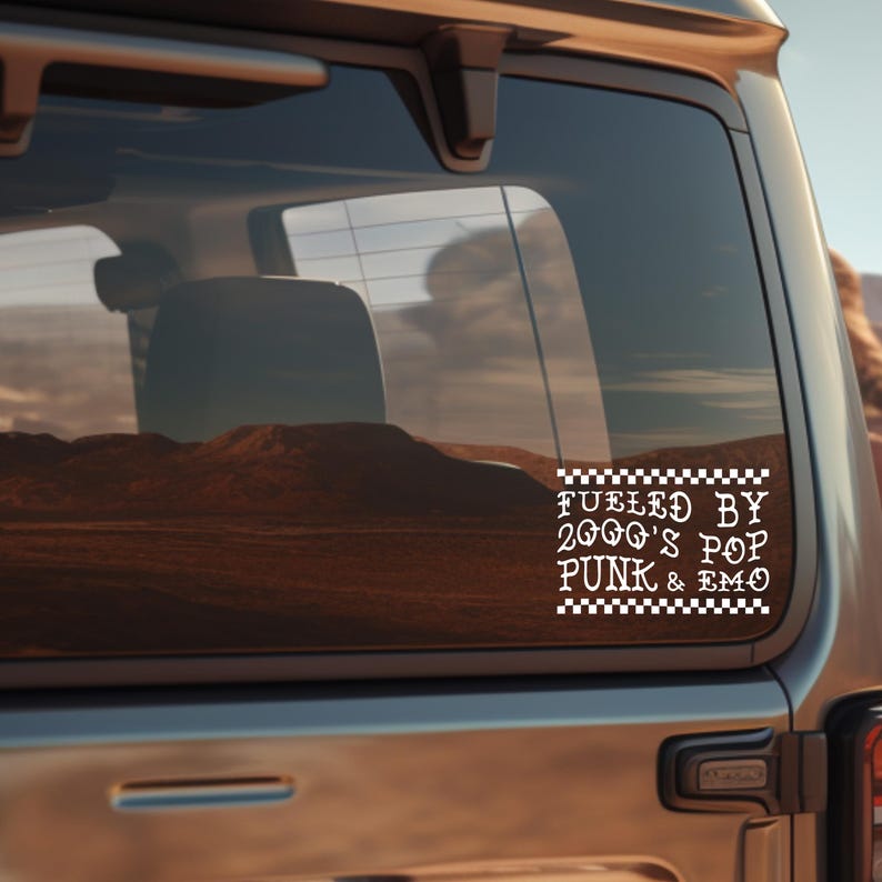 May include: A white vinyl sticker on a car window with black checkered borders. The sticker says "Fueled by 2000's Pop Punk & Emo".