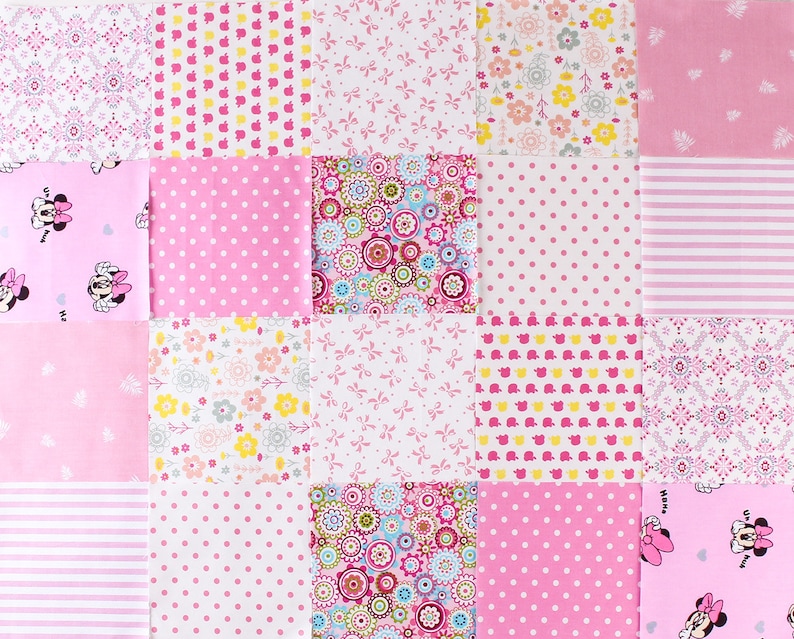 May include: A pink and white patchwork quilt with various patterns, including polka dots, flowers, and bows. The quilt features a Minnie Mouse design in the top left and bottom right corners.