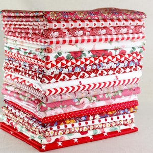 May include: A stack of folded fabric in various red and white patterns. Designs include floral, gingham, polka dots, and geometric shapes. The fabrics are neatly arranged, showcasing a variety of textures and prints, suitable for sewing and crafting projects.