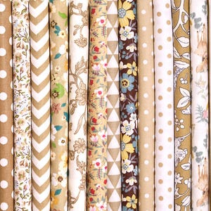 May include: A selection of rolled fabric bolts featuring diverse patterns and colours. Designs include polka dots, floral, geometric, and plaid in shades of brown, beige, and white. Suitable for sewing, quilting, or craft projects.