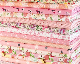 May include: A pile of folded fabric in shades of pink, with floral, star, and fruit patterns. The fabrics are neatly stacked, displaying a range of designs and textures, ideal for sewing or craft projects.