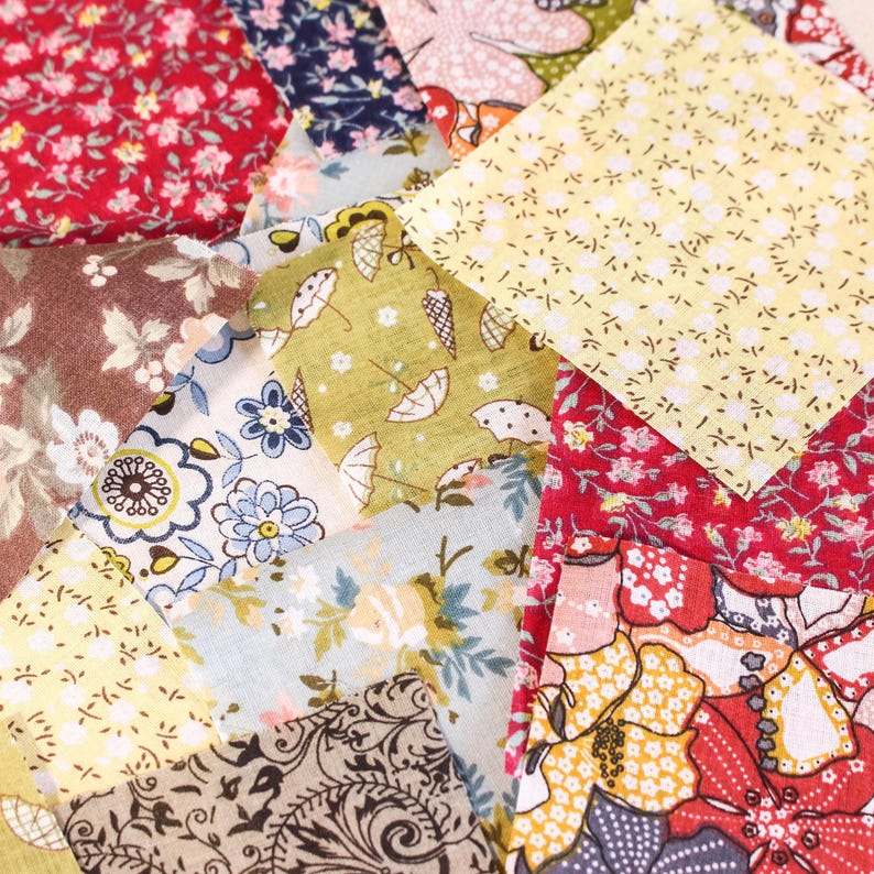 Pode incluir: Uma cole&ccedil;&atilde;o de quadrados de tecido coloridos com desenhos florais e estampados. Os tecidos apresentam uma variedade de cores, incluindo vermelho, amarelo, azul e verde, com pequenos motivos florais e de guarda-chuva. Ideal para projetos de patchwork e artesanato.