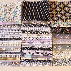 May include: A collection of 40 fabric squares with various patterns and colours, including floral, geometric, polka dot, and plaid. The fabric squares are arranged in two rows of 20.