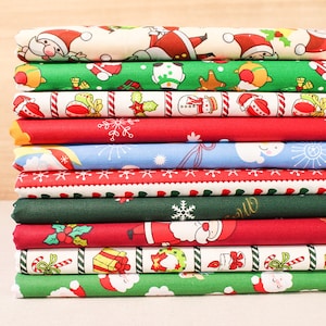 May include: A stack of ten fabric squares with Christmas-themed prints. The prints feature Santa Claus, snowmen, candy canes, snowflakes, and holly.