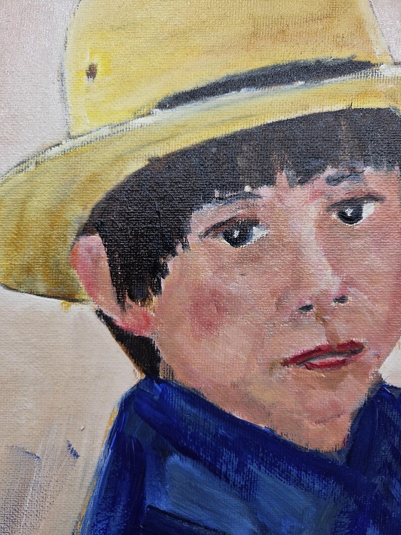 May include: Oil painting portrait of a young person wearing a yellow hat and a blue shirt. The subject has dark hair, fair skin, and a slightly somber expression. The artwork is painted on canvas.