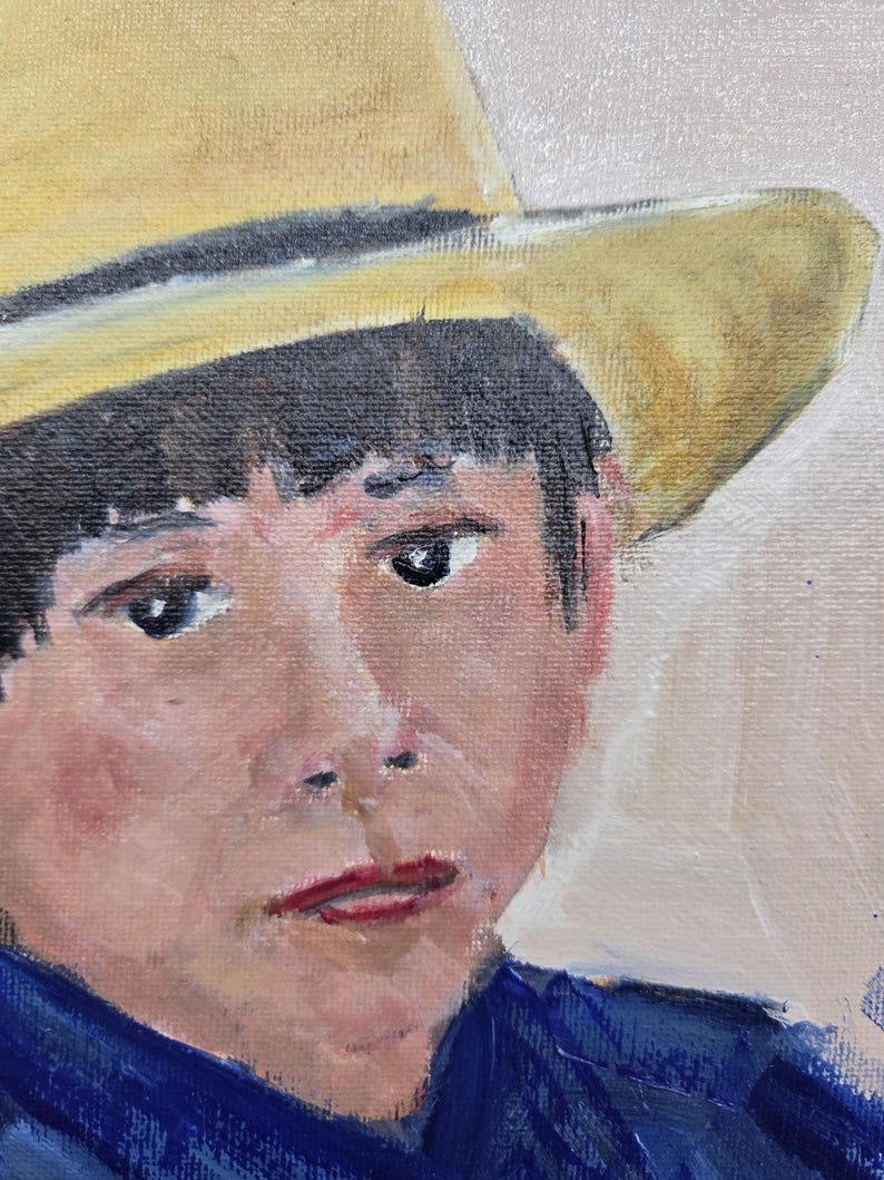 May include: Oil painting portrait of a person wearing a yellow hat and a blue shirt. The person has dark hair and is looking at the viewer. The painting has a soft, painterly style.
