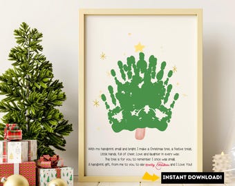 May include: Framed print featuring a green handprint Christmas tree design with a yellow star and snowflakes. The text reads, "With my handprint... I make a Christmas tree..." and "Instant Download!" The print is in a light-colored wooden frame.