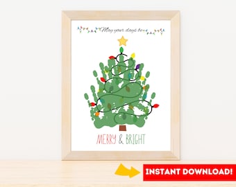 May include: A framed print featuring a green handprint Christmas tree decorated with colorful lights and a gold star. The text "May your days be..." and "MERRY & BRIGHT" are displayed. The frame is light brown.