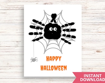 May include: A printable Halloween card featuring a black spider with googly eyes on a gray web. The text "Happy Halloween" is printed in orange below the spider.