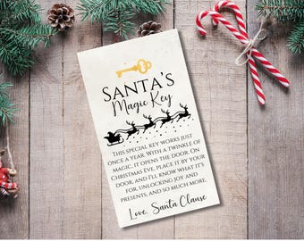 May include: A white card with black text that reads "SANTA'S Magic Key" and explains that the key works once a year on Christmas Eve. The card features a black silhouette of a key and a sleigh pulled by reindeer.