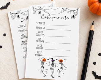 May include: Two white rectangular voting cards with black text and graphics. The cards feature the heading Cast your vote, a list of categories including Scariest, Funniest, Most Creative, Most Original, Best Couple, and Best Overall, and three skeletons.