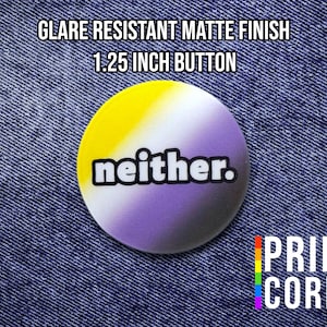 May include: A 1.25-inch button with a matte finish, featuring a non-binary pride flag design. The button has a yellow and purple gradient with the word "neither." in white. The button is on a denim background. The Pride Cords logo is visible.