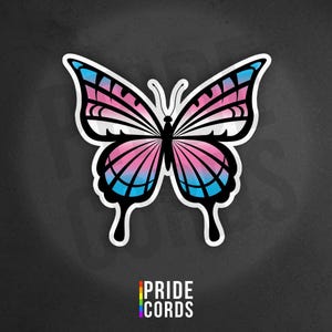 May include: A white ceramic mug with a black handle and the text "But First, Coffee" in a black, handwritten-style font. The mug is on a white surface.