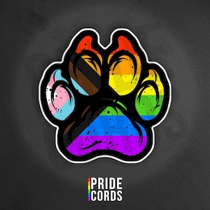 May include: A sticker featuring a paw print design with a rainbow color scheme, including the colors of the Pride flag and other LGBTQ+ flags. The sticker has a black outline and the text "PRIDE CORDS" at the bottom.
