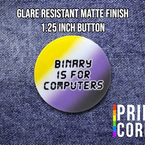 May include: A 1.25-inch button with a matte finish, featuring a non-binary pride flag design in yellow, white, and purple. The text "BINARY IS FOR COMPUTERS" is displayed. The button is set against a denim background.