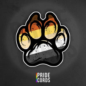 May include: A sticker featuring a paw print design with the colors of the Bear Pride flag. The paw print has a black outline and a white border. The text "PRIDE CORDS" is at the bottom in a rainbow color scheme.