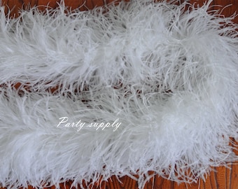 May include: White ostrich feather boa. The boa is soft and fluffy, and it is perfect for adding a touch of elegance to any outfit.