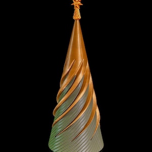 May include: A decorative Christmas tree with a spiral design. The tree is primarily gold and green, with a star on top. The tree is approximately 25 cm tall.