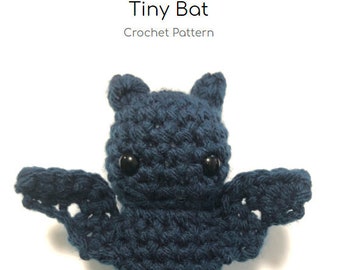 May include: A crocheted blue bat with black eyes. The bat is a small, handmade toy. Tiny Bat Crochet Pattern.