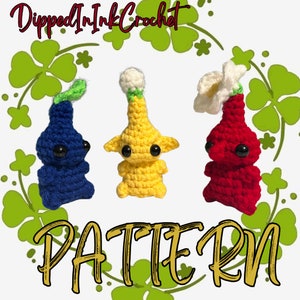 May include: Crochet pattern for three amigurumi characters. The characters are blue, yellow, and red. The characters have large eyes and are standing on a green background with clover leaves.