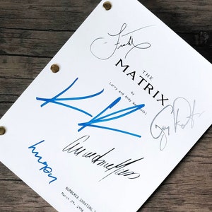 May include: A white page with the title "The Matrix" and the text "by Larry and Andy Wachowski" and "Numbered Shooting Script March 29, 1996". The page has several signatures in blue and black ink.