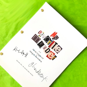 May include: A white script with the title "My Favorite Murder" in colorful cut-out letters. The script is signed by Karen Kilgariff and Georgia Hardstark. The text "Episode Two: My Second Best Murder" is also included.