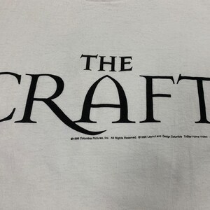 May include: White t-shirt with the black text "THE CRAFT" in a stylized font. Below the text is the copyright information for Columbia Pictures and TriStar Home Video. A vintage tee.