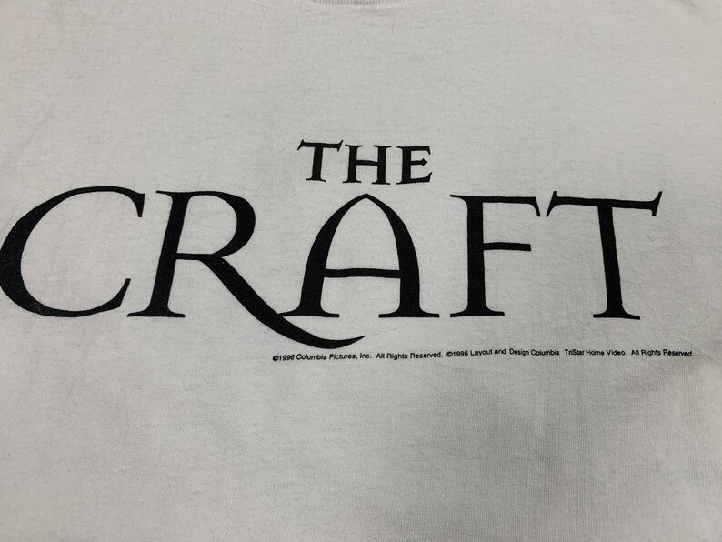 May include: White t-shirt with the black text "THE CRAFT" in a stylized font. Below the text is the copyright information for Columbia Pictures and TriStar Home Video. A vintage tee.