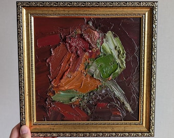 May include: A square oil painting featuring thick, impasto brushstrokes in shades of deep burgundy, burnt orange, and olive green. The artwork is encased in an ornate, metallic gold frame with a decorative, repeating embossed pattern along the edge.