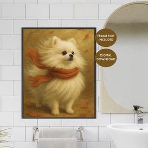 Pode incluir: Impressão emoldurada de um cão Pomerânia fofo, cor creme, usando um cachecol cor de ferrugem. O cão está em um fundo outonal quente com folhas caindo. As palavras "FRAME NOT INCLUDED" e "DIGITAL DOWNLOAD" são visíveis.