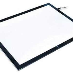 May include: A black framed light pad with a white surface. The light pad is turned on and illuminating the surface.