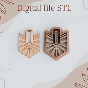 May include: Two digital STL files for 3D printing. The design features a geometric shape with a sunburst pattern and a rectangular cutout in the center. The files are for creating earrings.