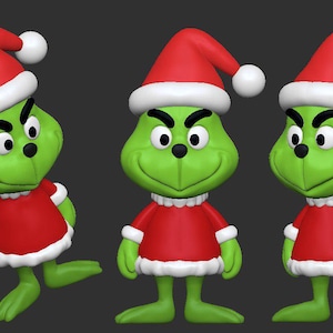 Op de afbeelding: Drie groene figuren die lijken op een kerstpersonage, elk gekleed in een rode outfit met witte rand en een bijpassende rode hoed met een witte bal. De figuren hebben een ondeugende uitdrukking en staan in verschillende posities.