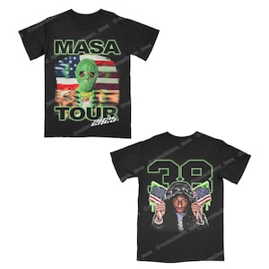 May include: Black t-shirts with graphic designs. One shirt features the text "MASA TOUR 2425" with an alien-like figure and an American flag. The other shirt displays the number "38" and a person holding American flags.